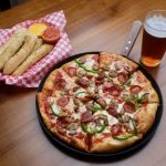 Greek's Pizzeria pizza, beer, and bread sticks