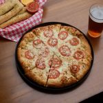 Greek's Pizzeria pizza, beer, and bread sticks